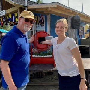 Camden Rotary Club Member Tom Pine assists Tara Barker as she draws the winning raffle tickets for the club’s cash raffle. Proceeds will benefit local nonprofit organizations. Camden Rotary, Cash Raffle,