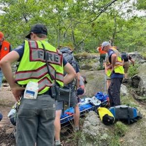 First responders tend to the injured woman, stabilizing and then transporting her down the trail from the top of Bald Mountain in Camden. (Photo courtesy Camden Fire Dept.)