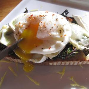 Poached egg over melted brie and sauteed kale on toast. Photo by Kay Stephens