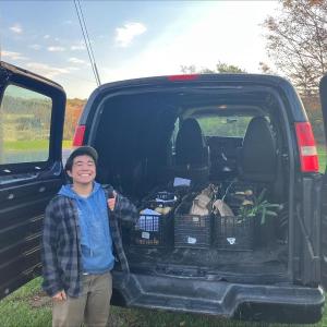Matsu Hikida, Erickson Fields Program Assistant, loads the van with 12 heavy crates of produce for deliveries to four food pantries. (Photo courtesy MCHT)
