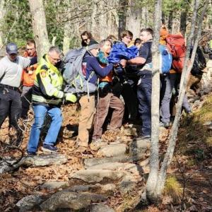 Camden Fire and Rescue, Coastal Mountains Search and Rescue volunteers, Camden police officers and a North East Mobile Health Services EMS crew member carefully descended Mt. Battie with an injured hiker, moving the basket hand-over-hand at a steady, methodical rate down to a waiting ambulance. (Photo courtesy Camden Fire and Rescue)