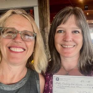 Patrisha McLean, CEO/Founder of Finding Our Voices, with Misty Mallar of Nautilus Seafood and Grill in Belfast. The $500 donation to Finding Our Voices represents 20 percent of sales of 250 slices of Limoncello cake sold during July. (Photo by Patrisha McLean)
