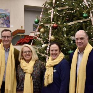 Patrisha McLean and Nicole Gogan of Finding Our Voices are flanked by Camden National Bank President Greg Dufour on the right and his successor Simon Griffiths on the left. “Mr. Dufour and Mr. Griffiths were good sports about wearing our trademark yellow for the photo,” said McLean, in a news release. Yellow is the nonprofit’s color because, according to McLean, “we are survivors of domestic abuse who have managed to cross over into the light of freedom and safety and are now shining a light for the benefit of all in Maine.” (Photo by Viktorie Mathiau)