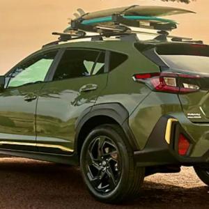 For 2024, the Crosstrek has been redesigned. The Sport model sits 8.7 inches high on 18-inch alloy wheels with all-terrain tires. Alpine Green is one of the hot colors this year, and the Sport trim gets yellow and black accents and special badges. The roof rack is an available option.