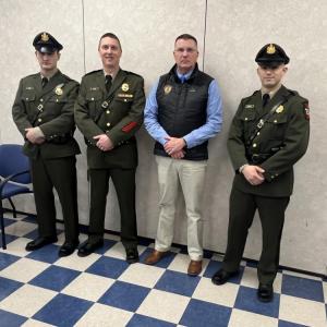 Pictured after recently graduating from the Maine Criminal Justice Academy are Callahan Crosby (left) and August Campbell (right) with Marine Patrol Colonel Matthew Talbot (2nd from left) and Department of Marine Resources Commissioner Patrick Keliher (2nd from right). (Photo courtesy Department of Marine Resources)