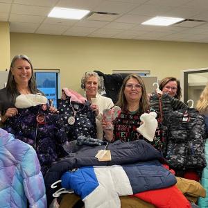 Maine Water customer service team in Saco with some of the 125 winter coats collected for donation in 2023. (Photo courtesy Maine Water)