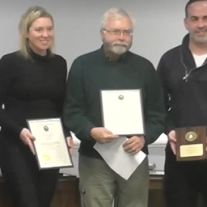 Erik Laustsen, center, poses for pictures with Mayor Nichole Kalloch and City Councilor Adam Lachman during a commendation ceremony, Jan. 8, 2024.