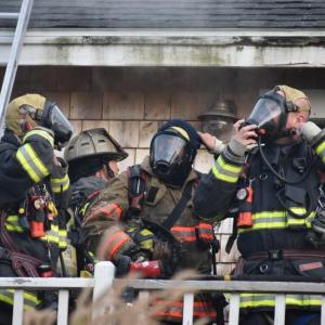 Local firefighters adjust their Self Contained Breathing Apparatus at a fire scene in South Thomaston, Nov. 29, 2021. (Photo by Sarah Thompson)