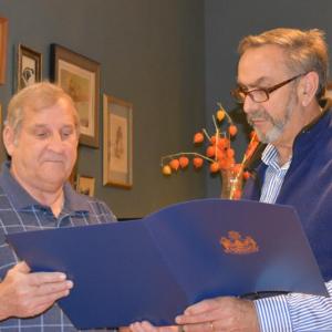 Retiring Knox County Regional Airport director Jeffrey Northgraves (left), looks on as State Legislator Representative Dave Miramant reads aloud from Northgraves’ certificate of recognition in 2019 when Knox County legislators surprise airport Manager Jeff Northgraves with state recognition. (Photo by Sarah Thompson)