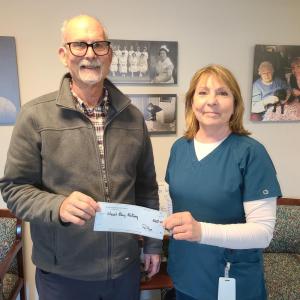 West Bay Rotary member Sandy Cox presents Camden Area District Nursing Association Executive Director Judi Lydon with the proceeds from this year’s West Bay Rotary Super Bowl Raffle.