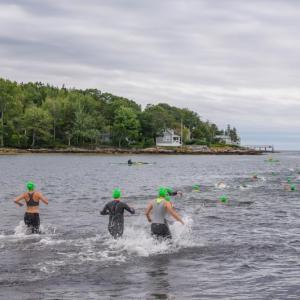 Swimmers enter the water at Pemaquid Beach during the 2023 triathlon. (Photo courtesy Bob Kofman)