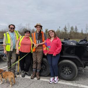 From left to right, Eric Itzel, Emily McBrayer, Marcy Bonner, Chalen Mitchell, and Griffin the Dog, fill the cart with trash during Thomaston’s clean-up day, May 4. (Photo courtesy Kathleen Norton)