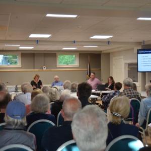 A May 28 public information meeting about Article 3, a proposal to spend $33.7, plus interest, on building Rockport’s own sewer treatment facility. At the table in front, left to right, Rockport Select Board members Kim Graffam, Michael Thompson, Denise Munger, with Rockport Wastewater Task Force chair Bill Bow, Town Manager Jon Duke and Rockport Finance Director Megan Brackett. (Photo by Lynda Clancy)