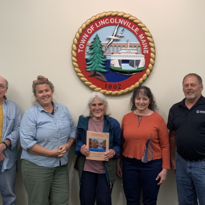 Lincolnville Select Board members Mike Ray, Ladleah Dunn, with Corelyn Senn in the middle, and board members Robyn Tarantino and Keryn Laite, June 6, at the dedication of the 2024 Town Report to Senn. (Photo by Lynda Clancy)