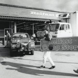 Volunteers moving the Co-op sign from the former Main Street Location to the current location
in 1993. (Photo courtesy Belfast Historical Society and Museum/provided for publication by Belfast Free Library)