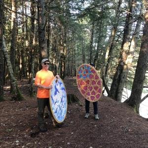Peter Walls and Allegra Kuhn install their pendants at Stover Preserve. (Photo courtesy Waterfall Arts)