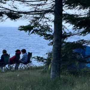 A small pack of Lincolnville boys enjoying camping at the shore on a July 4 evening. (Photo by Tracee O’Brien)