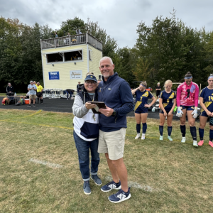 Coach Townsend is presented with a 300-career win plaque and given a game ball from Thursday's night win against Belfast.
