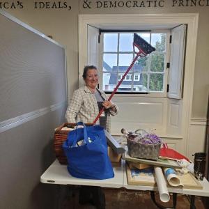 Noreen Mullaney, along with other volunteers, cleans the lower level of the Knox Museum during 2023's Together for Thomaston Event. (Photo by Kendray Rodriguez)