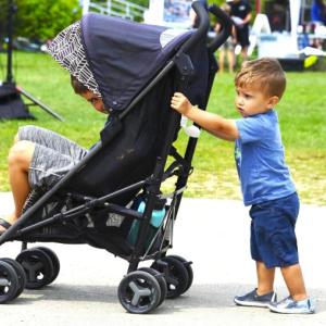 This young man pushed a stroller with his big brother as passenger along the Harborwalk at the 17 th annual Belfast Harbor Fest, hosted by Belfast Rotary Club, on Aug. 18.
