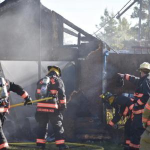 Thomaston firefighters deal with the embers of a shed fire Friday morning, Oct. 25, 2024. (Photo by Sarah Thompson)