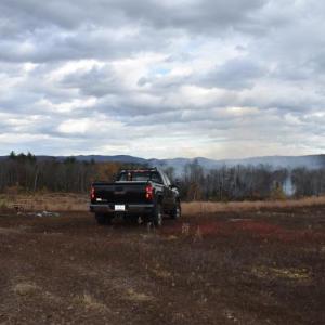 A Union fire truck and a Maine Forest Service truck overlook a wildland fire that ignited Sunday afternoon, Oct. 27, 2024. (Photo by Sarah Thompson)