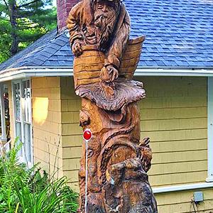 This detailed wooden carving sits at the corner of one property, leading many to slow slightly to take in the intricacies of the art piece.  (photo by Erica Thoms)