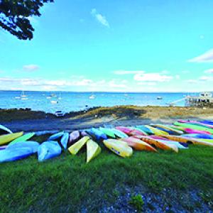 Kayaks lay shore at the Temple Heights beach.  (Photo by Erica Thoms)