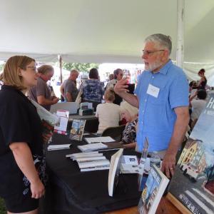 Author Philip C. Baker chats with a festivalgoer at Maine Author's Publishing's Book Festival. Photo courtesy Maine Author's Publishing Author Philip C. Baker chats with a festivalgoer at Maine Author's Publishing's Book Festival. Photo courtesy Maine Author's Publishing