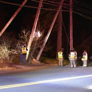 Firefighters and Central Maine Power reps assess the remnants of a broken utility pole at Ingraham Drive and Bayside, in Owls Head. (Photo by Sarah Thompson)