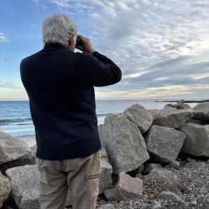 Jeff scanning shorebirds at Fortune's Rocks in Biddeford. A cave swallow had been seen nearby earlier that day, but the authors didn't know it at the time. Courtesy of Allison Wells