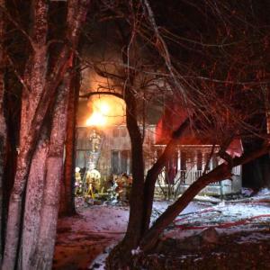 Well after big flames were suppressed, sparks found oxygenation from a new hole in the roof. (Photo by Sarah Thompson)
