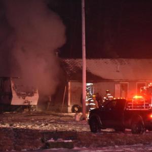 Firefighters focused on two fire scenes after flames from a camper fire spread. (Photo by Sarah Thompson)