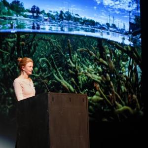 Allison McKellar presents at the November 2024 PechaKucha Night at the Camden Opera House. (Photo by Michael O’Neil)