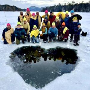Cold Tits Warm Hearts spent two hours carving out a heart from foot-thick ice on Mount Desert before dipping in the frigid water as a way to show love for Maine’s domestic abuse victims/survifors in the second annual Statewide Finding Our Voices Fundraising Dip.  (Photo courtesy Liz Cutler)