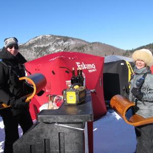 Tim Savard and Emily Eplan model two handmade toboggan shelves to hold their drinks. Photo by Kay Stephens