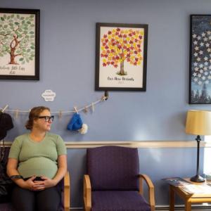 Rachel Keidan sitting in a waiting room.