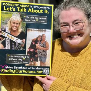Ashley Vissers holds the poster featuring her and her mother. On March 12, Ashley joined four other domestic abuse survivors in Belfast, where 20 businesses said YES to displaying the posters. (Photo by Patrisha McLean)