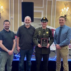 Maine Marine Patrol Specialist Dan Vogel (second from right) receives the 2025 Maine Lobstermen’s Association Officer of the Year Award during the Fishermen’s Forum. Pictured with Specialist Vogel are Deer Isle lobsterman and MLA Board Member Brian Billings (left), Beals Island lobsterman and MLA Board Vice Chairman Sonny Beal (2nd from left), and Marine Patrol Colonel Matt Talbot Beal (right). (Photo courtesy Department of Marine Resources)
