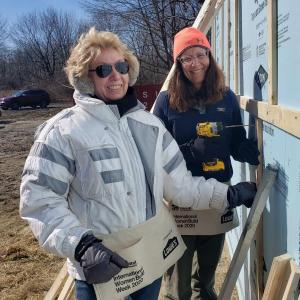 A dedicated volunteer installs house wrap and siding to prevent mold, rot and energy loss, creating a healthier home. (Photo courtesy Midcoast Habitat for Humanity)