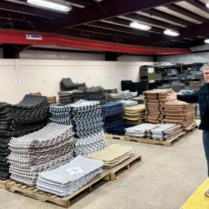 David Whitney fully supports the tightening immigration policies, and his company was the first in Maine to join a voluntary partnership initiative between the federal government and private sector employers. Photo by Joyce Kryszak. David Whitney poses for a photo in his warehouse.