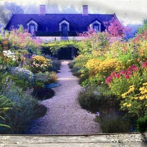 The house was built in 2006, in order to house 11,000 books on agriculture. The painting captures the front garden in full bloom.
