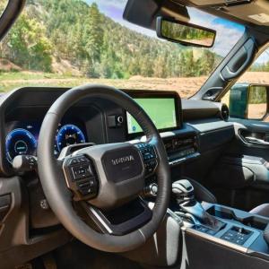Today’s 250-Series Land Cruiser packs functionality, comfort and convenience into the sort of broad-shouldered and squared-off cabin that suits a brawny off-roader with decent street performance. The switches around the shift lever control the two-speed transfer case, the center and rear locking differentials and the e-brake.