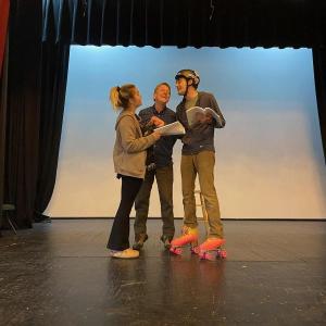 AnnMarie Lowerre, James Cook, and rollerskating Jack Sullivan rehearse for The Drowsy Chaperone. (Photo courtesy Watts Hall Community Players)