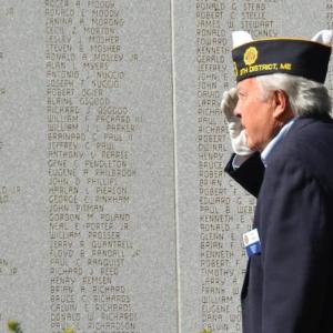 The annual Memorial Day Parade and remembrance ceremony began at 9 a.m., May 26, with the first stop at the Camden Village Green to lay a wreath at the Veterans Honor Roll, and a moment of silence for those who lost their lives in conflicts. Veteran Ray Lewis stands at attention to honor the dead. (Photo by Lynda Clancy) c
