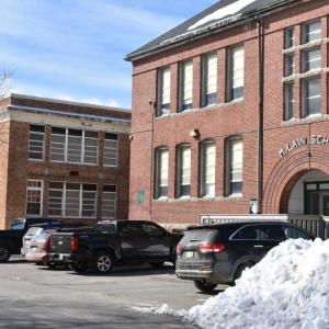 As a developer is named for a long anticipated affordable housing project at the McLain School building, in the foreground, the fate of the Lincoln Street Center, in the background, is questioned. (2018 file photo by Sarah Thompson)