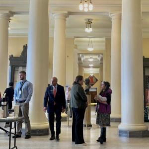 people gather in the halls of the statehouse
