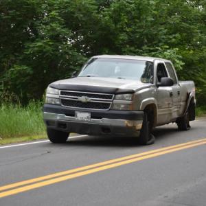 While All Directions hauls the car away, the pickup truck sits idle in front of a first reponder's car. (Photo by Sarah Thompson)