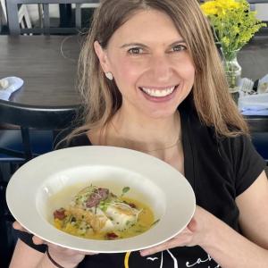 Danielle Turner with the "Into the Light!" roasted cod with pearled couscous, tomato jam, olive tapanade, and safffron nage at the Harborview Bistro at the East Wind Inn. (Photo by Patrisha McLean)
