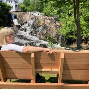 President, Vicki Mast, tries our the new table and seating unit created by The Hatchery.